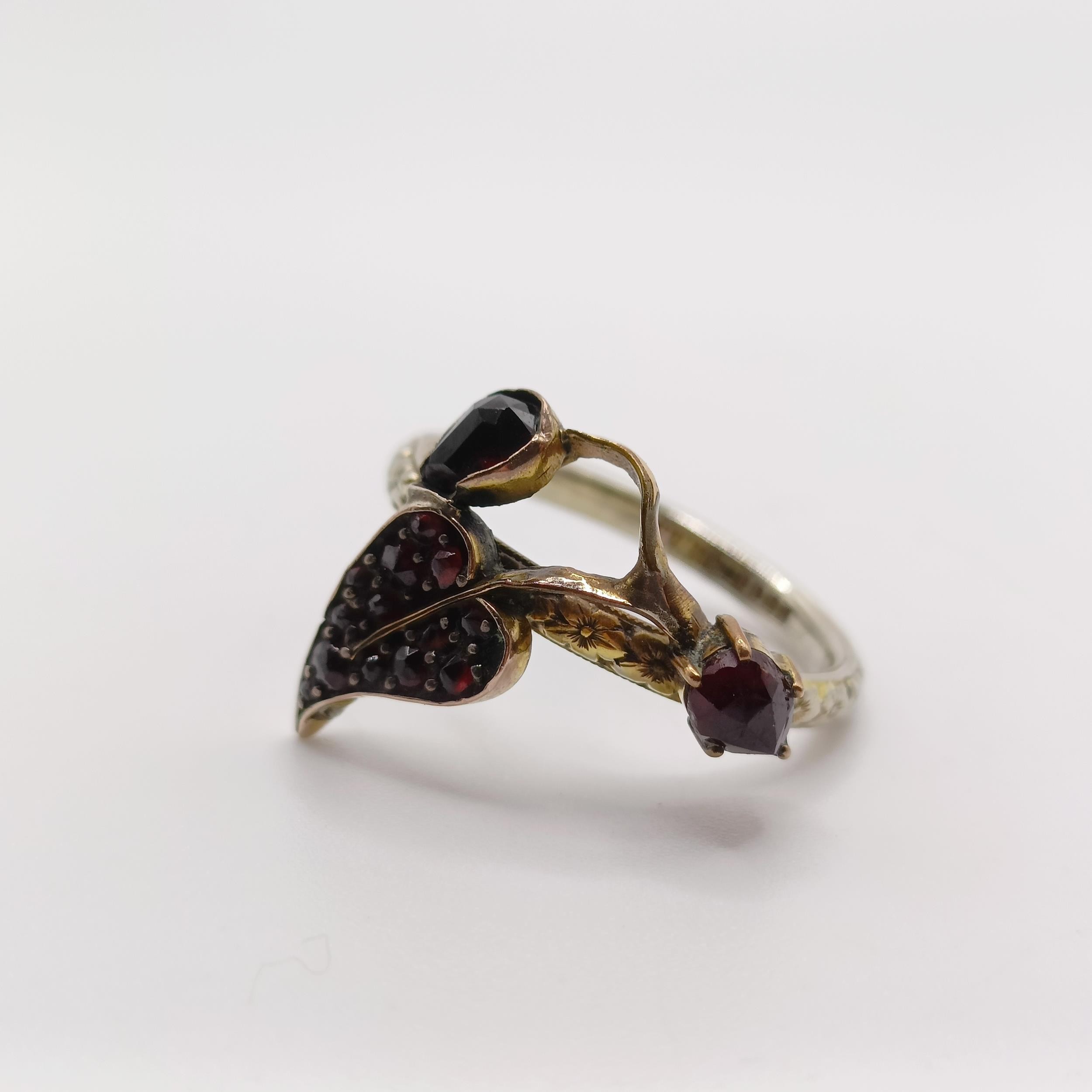 A platinum wedding band, ring size K, and a 18ct gold wedding band, with a garnet mount added, - Image 2 of 7