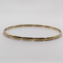 A yellow coloured metal bangle 8.8 g untested
