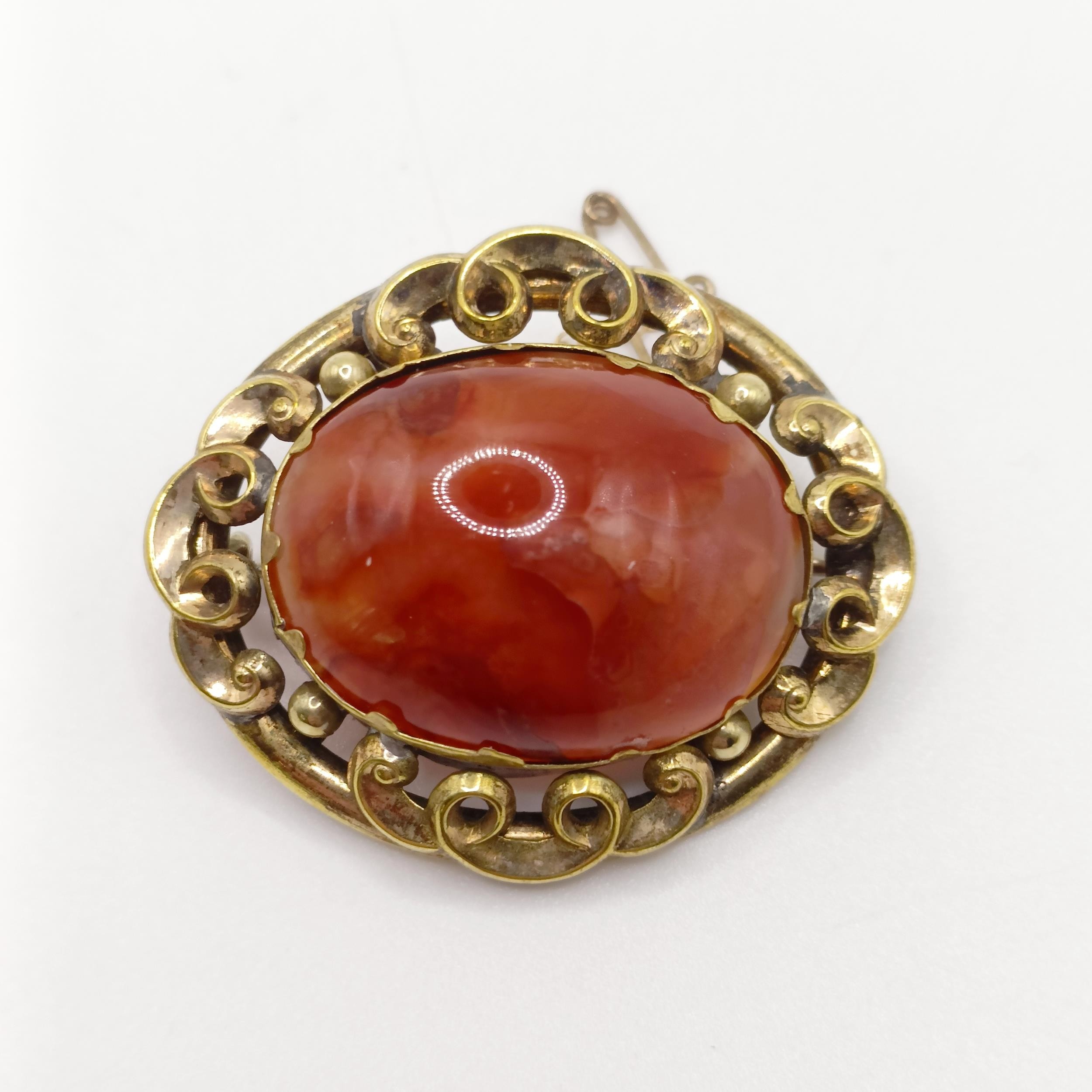 An early 20th century yellow coloured metal and amber coloured stone brooch, and a yellow metal - Image 4 of 6