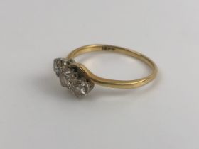 An 18ct gold and three stone diamond ring, ring size S