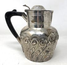 A Victorian silver hot water jug, with an ebonised handle