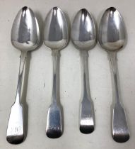 A George III silver fiddle pattern spoon, and three 18th century silver coloured metal spoons,