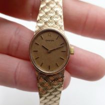 A ladies 9ct gold Omega wristwatch, with a 9ct gold strap, 28.1 g all in Area of damage to strap