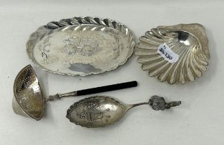 A shell shaped dish, Birmingham 1903, a caddy spoon, a sifter spoon, and an oval tray, various dates