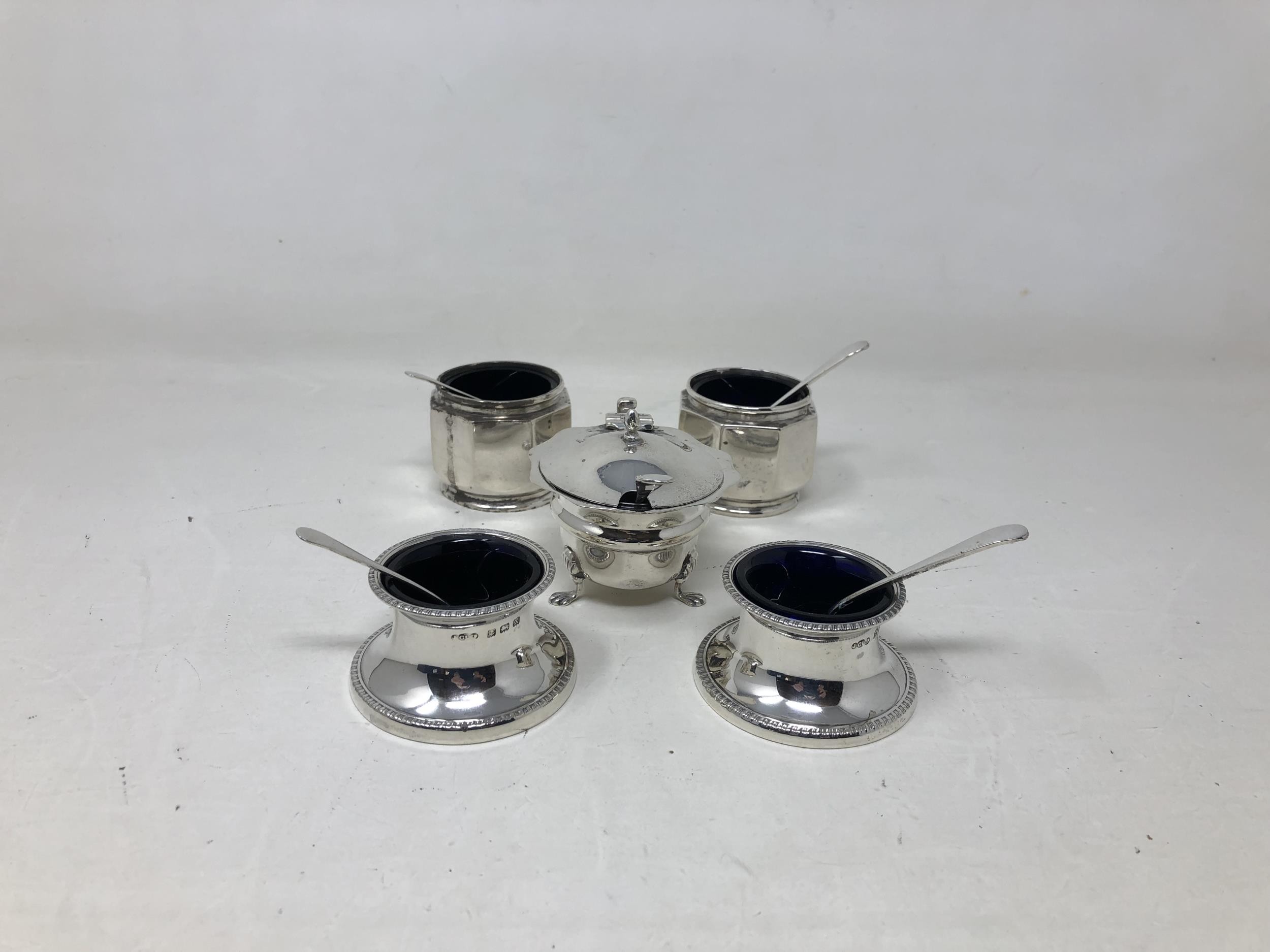 A pair of George V silver salts, with blue glass liners, another pair, a mustard pot and assorted