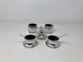 A pair of George V silver salts, with blue glass liners, another pair, a mustard pot and assorted