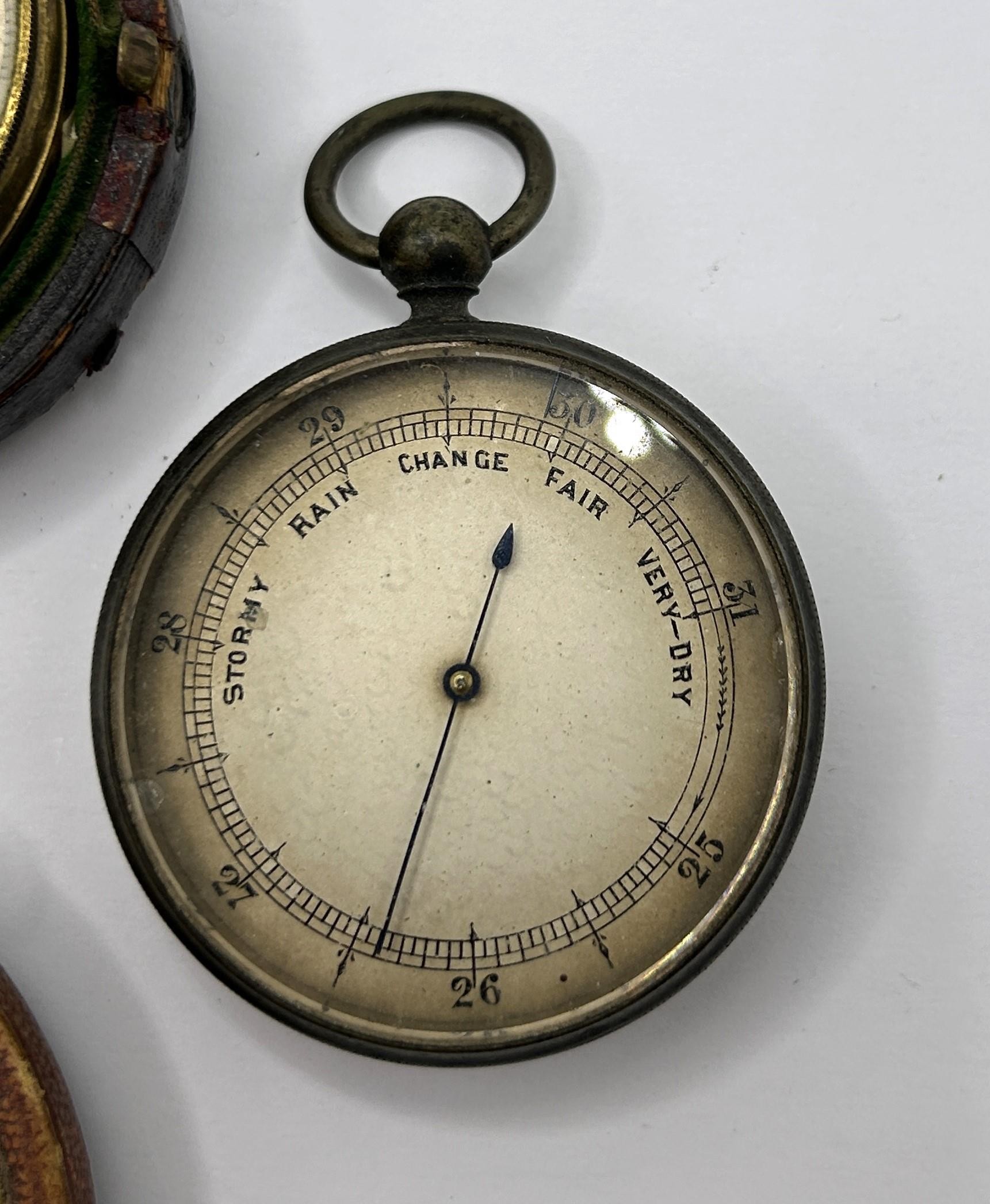 A pocket barometer, by Negretti & Zambra of London, No 18499, cased, another, cased, and another, - Image 4 of 5