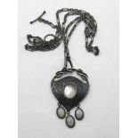 An Art Nouveau pewter and oval moonstone pendant, on a chain, with a receipt from Didier Antiques,