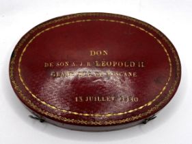 An early/mid 19th century French oval box, to hold two pocket watches, the cover tooled in gilt 'DON
