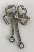 A late 19th/early 20th century diamond ribbon brooch with tassle terminals Length 50 mm Width 35mm