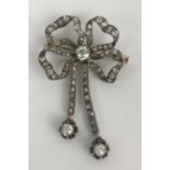 A late 19th/early 20th century diamond ribbon brooch with tassle terminals Length 50 mm Width 35mm