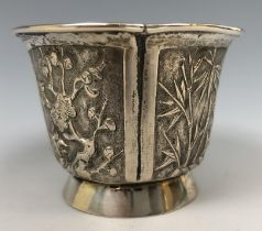 A Chinese silver coloured metal beaker, embossed flowers and foliage, 5.5 cm high 2.5 ozt,
