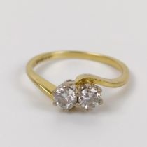 An 18ct gold and two stone diamond crossover ring, ring size N