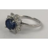 A sapphire and diamond cluster ring, ring size M