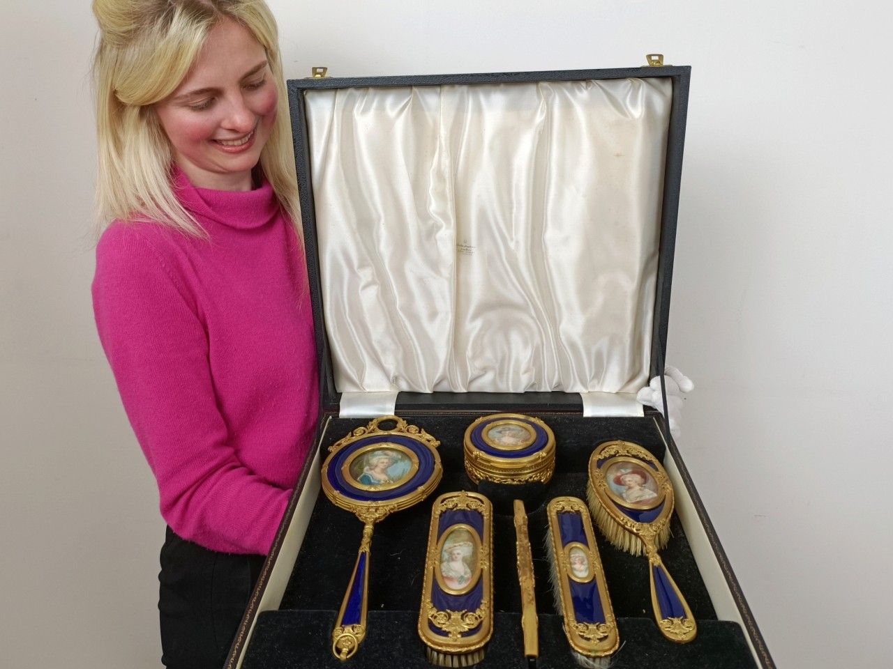 An impressive early 20th century gilt metal and blue enamel dressing table set, inset with