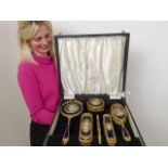 An impressive early 20th century gilt metal and blue enamel dressing table set, inset with
