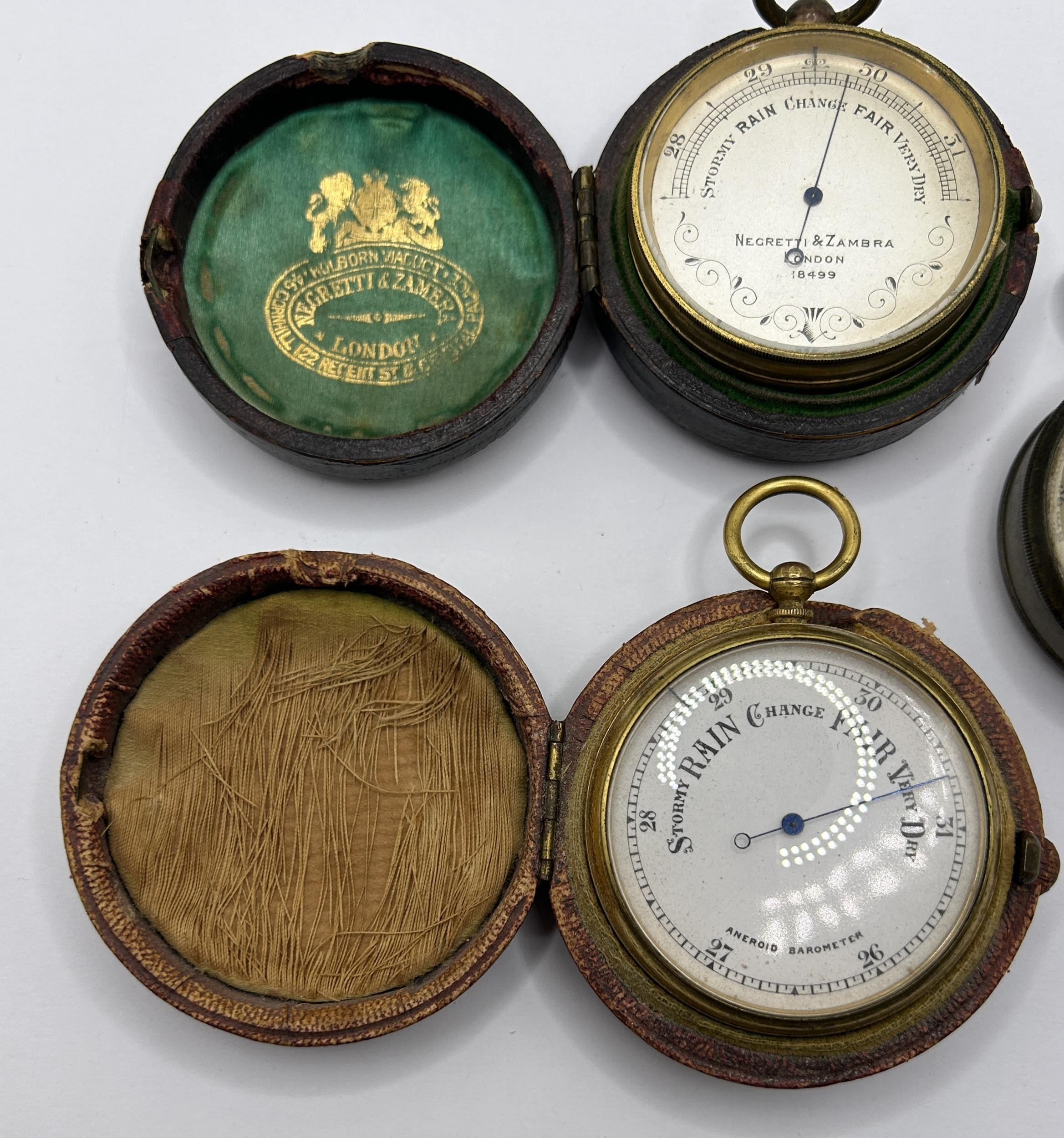 A pocket barometer, by Negretti & Zambra of London, No 18499, cased, another, cased, and another, - Image 3 of 5