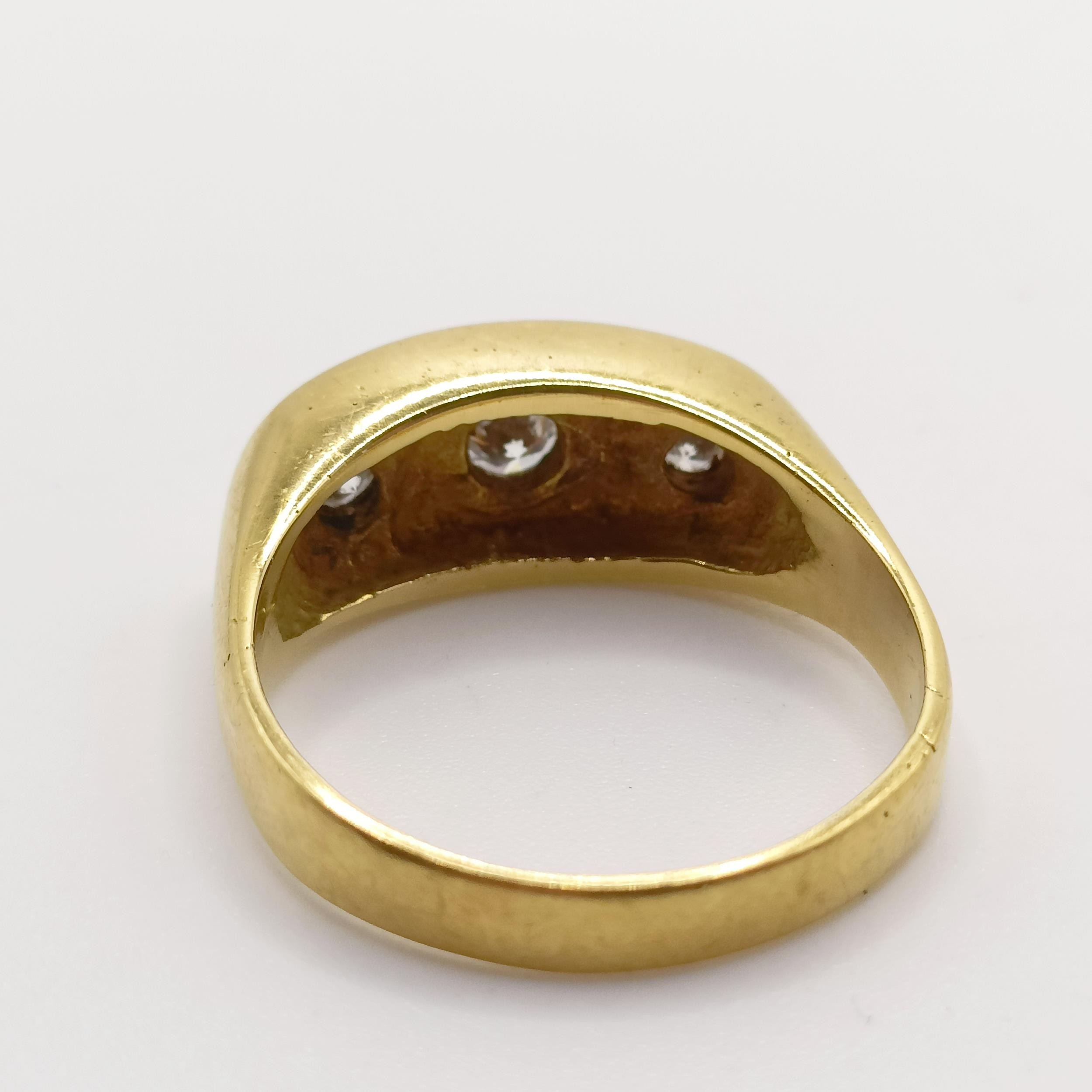 An 18ct gold three stone diamond gypsy set ring, ring size P 1/2 light ware due to use, no obvious - Image 3 of 5