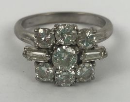 An 18ct white gold and diamond cluster ring, set with two baguette cut and seven brilliant cut