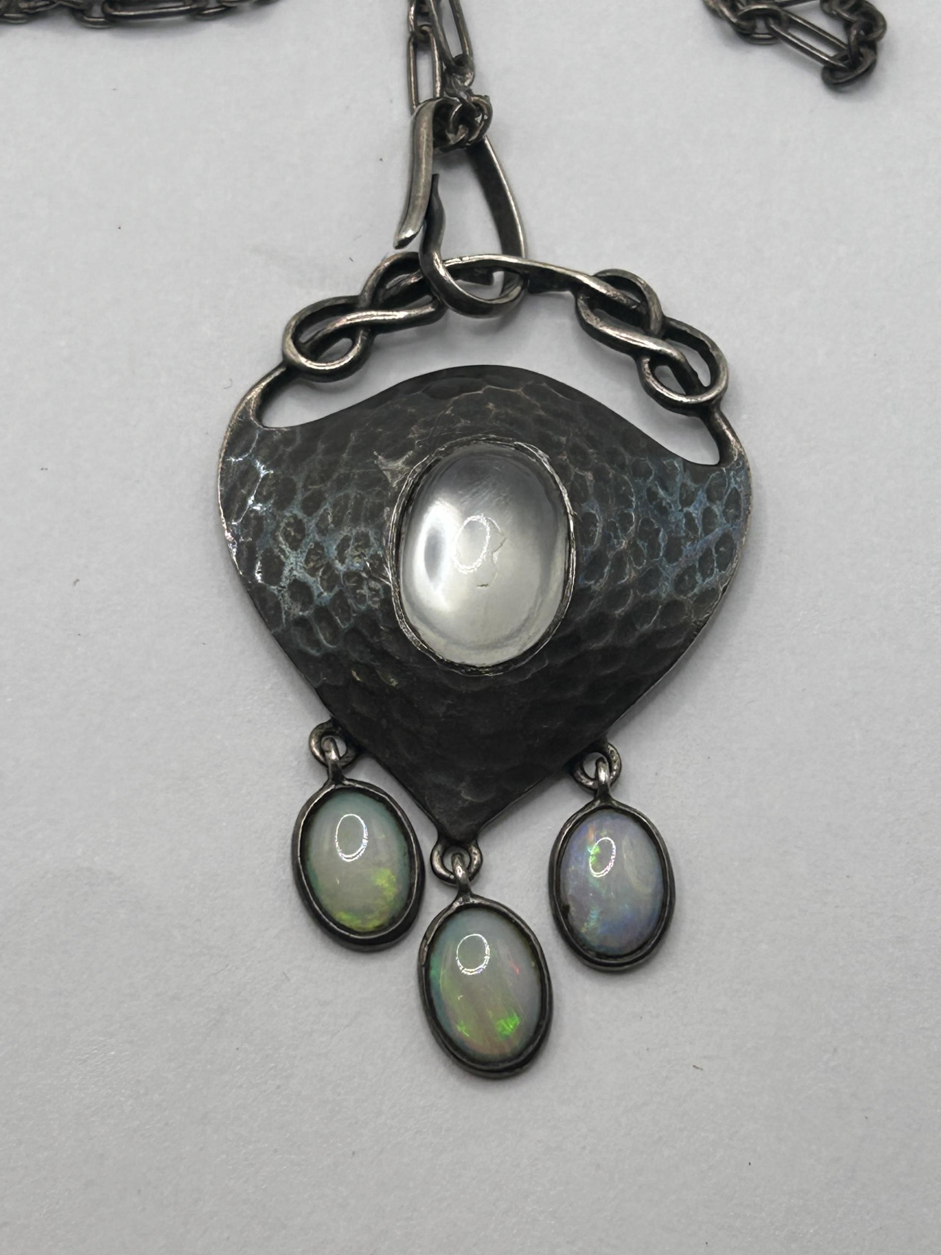 An Art Nouveau pewter and oval moonstone pendant, on a chain, with a receipt from Didier Antiques, - Image 2 of 5