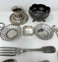 An Indian silver coloured metal sugar bowl, assorted teaspoons, a napkin ring, a pair of pierced