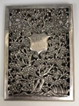 A Chinese silver coloured metal visiting card case, initialled, pierced prunus decoration, 11.5 cm