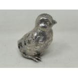 A novelty Continental silver coloured metal pepper, in the form of a chick, import marks for