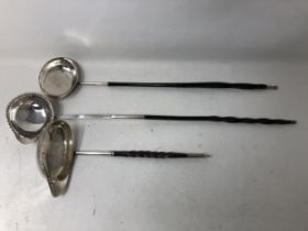A 19th century silver and carved wood toddy ladle, and two others (3)