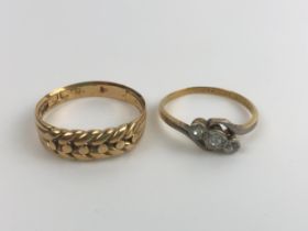 An 18ct gold ring, ring size R, 4 g, and a two stone diamond ring, ring size M (2) Two stone ring,