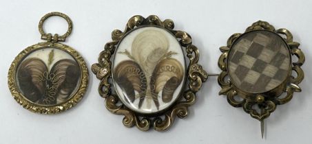 A 19th century gilt metal locket, inset with a lock of hair, and two others similar (3)