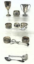 A George V silver goblet, a trophy cup, 2.1 ozt, assorted napkin rings and other items (box)