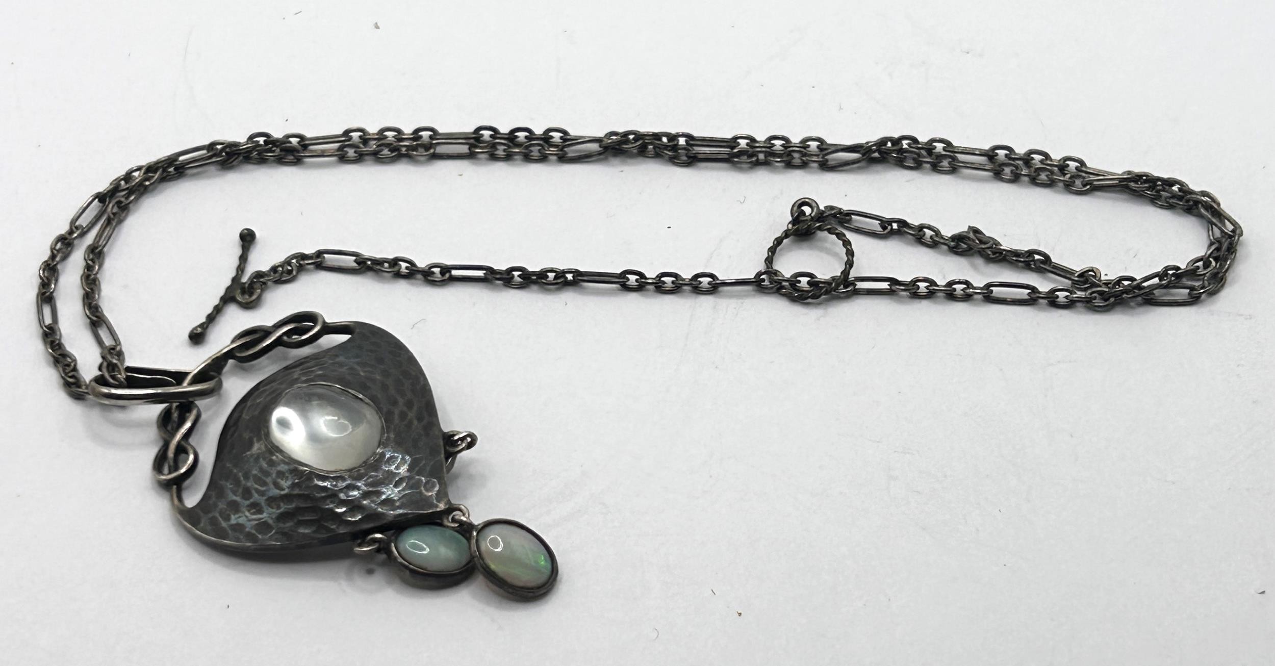 An Art Nouveau pewter and oval moonstone pendant, on a chain, with a receipt from Didier Antiques, - Image 4 of 5