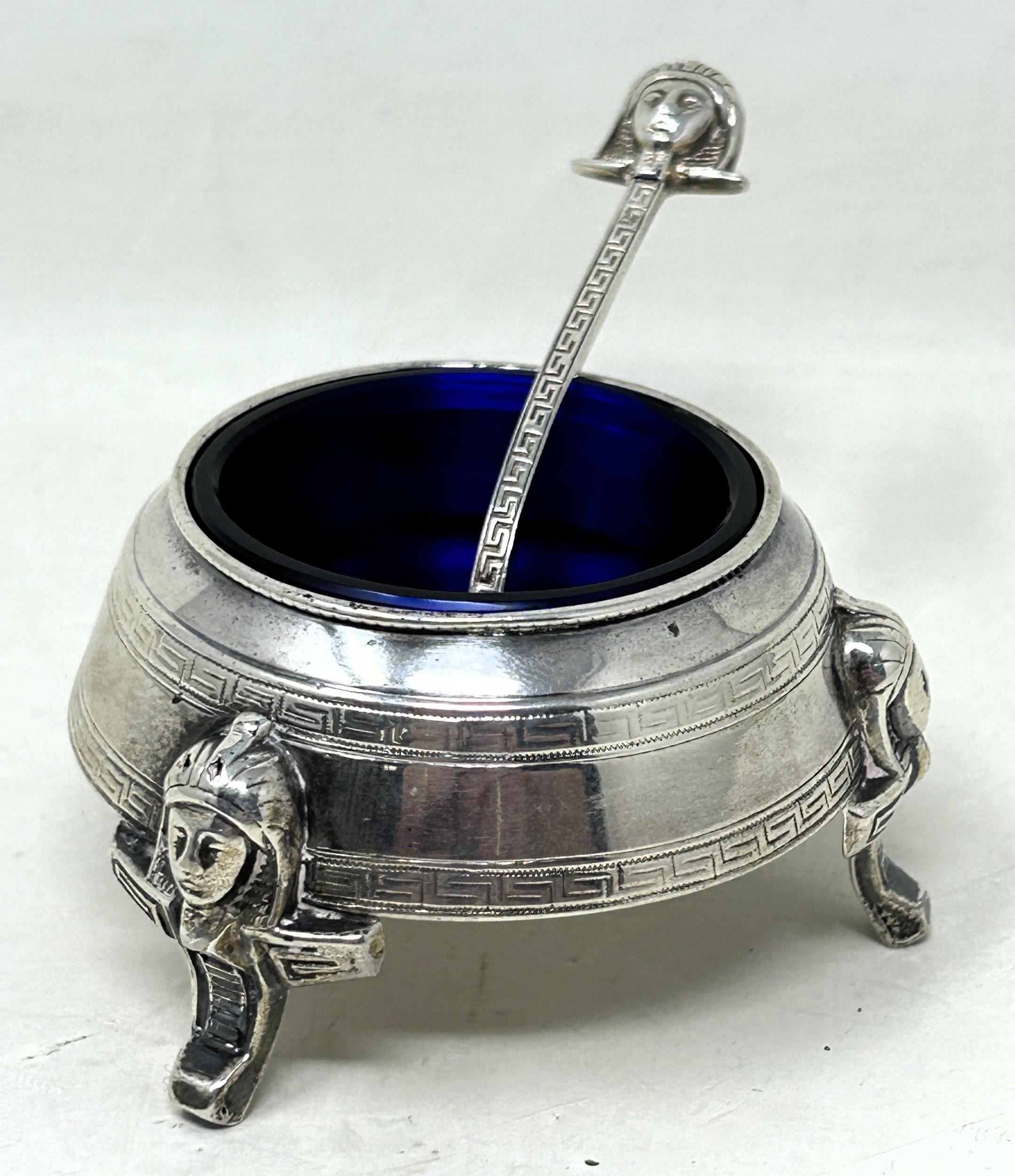 A Victorian Egyptian revival silver salt, Birmingham 1878, and a matching spoon (2) Light ware, no