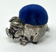 A novelty silver pin cushion, in the form of a pig, marks rubbed, 2.5 cm wide