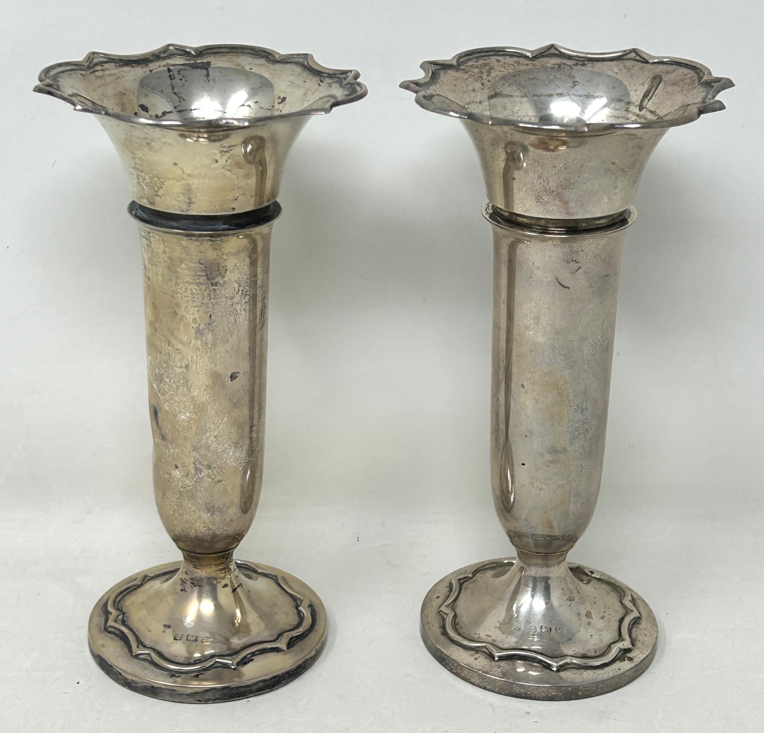 A pair of George V silver posy vases, Birmingham 1923, bases filled, 16 cm high (2)