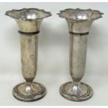 A pair of George V silver posy vases, Birmingham 1923, bases filled, 16 cm high (2)