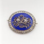 An early 19th French diamond, blue enamel, yellow and white metal oval brooch, decorated a basket of