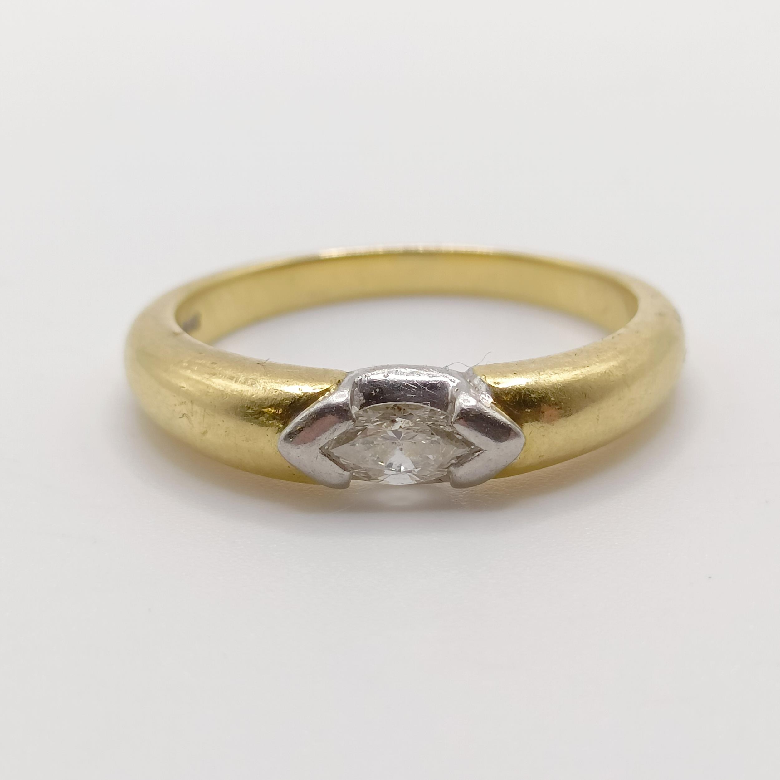 An 18ct gold and marquise cut diamond solitaire ring, ring size O