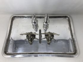 A pair of silver plated knife rests, in the form of bull heads, a silver pepper and salt, a silver