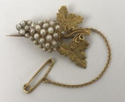 A yellow coloured metal and seed pearl brooch, in the form of bunch of grapes