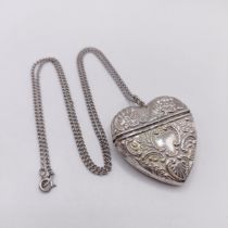 A silver heart shaped vesta, on a chain