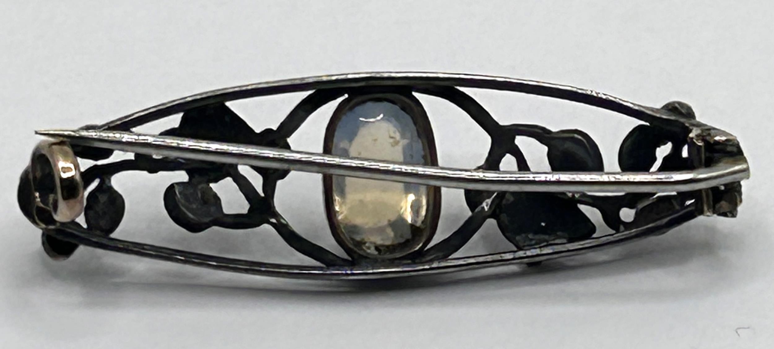 Attributed to Liberty, a pewter, moonstone and enamel brooch, believed to be by Jessie M King, - Image 2 of 3
