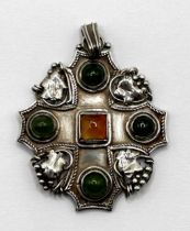 An Arts and Crafts silver coloured metal, green and amber stone pendant, by Jean Bassett, 5 cm