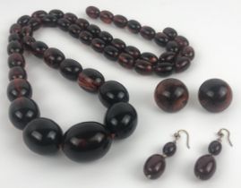 An amber necklace, and two similar pairs of earrings Provenance:  Sold on behalf of Tenovus Cancer