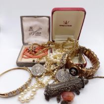 A coral and seed pearl brooch, a coral necklace, in a vintage jewellery box, and assorted costume
