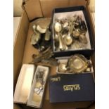 A silver plated two handle tray, assorted silver plated flatwares and a mirror