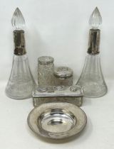 A silver dish, 2.2 ozt, a pair of silver mounted engraved glass perfume bottles, and three silver
