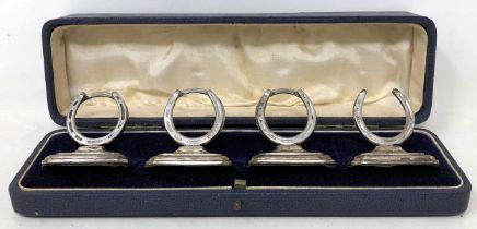 A set of Edward VII silver novelty menu holders, in the form of horseshoes, Birmingham 1904, cased