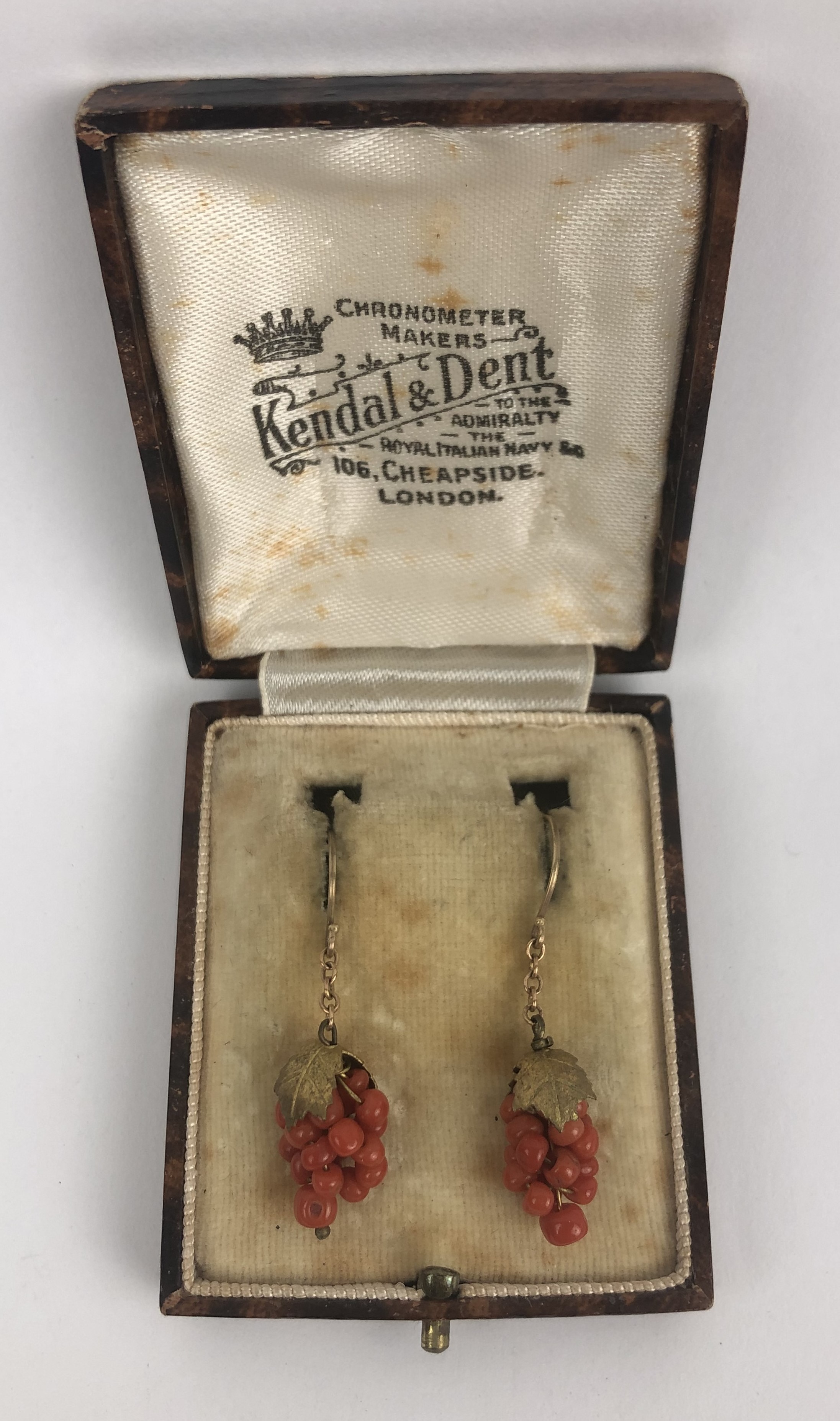 A pair of gilt metal and coral earrings, in the form of a bunch of grapes
