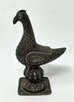 A Persian silver coloured metal mount, in the form of a bird, 10 cm high